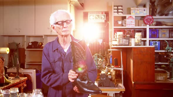 Shoemaker examining a shoe