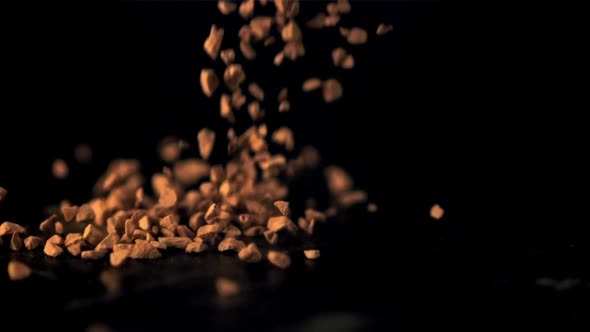 Super Slow Motion Soluble Coffee Pellets Fall on the Table