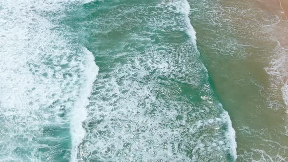 Beautiful Big Waves rolling from above breaking beach.drone shots.