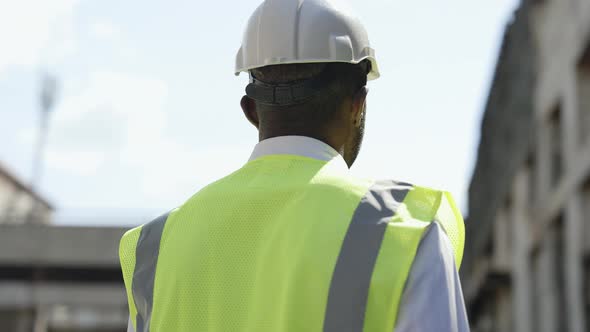 Focused Architect Looking Around at Construction Site