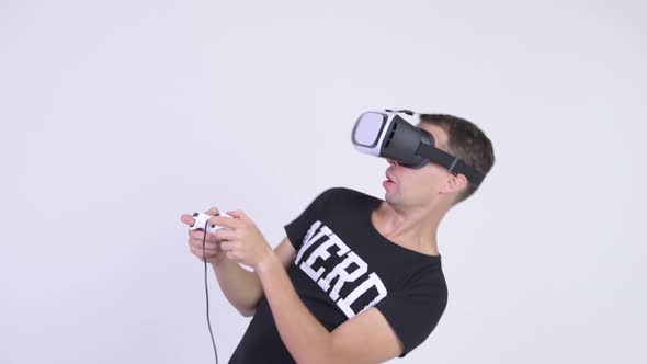 Happy Nerd Man Playing Games and Using Virtual Reality Headset