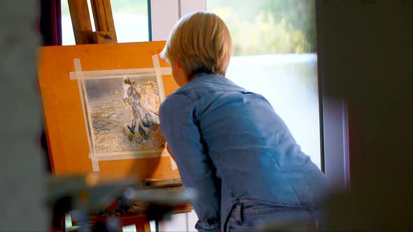 Female painter painting on a canvas at home 4k