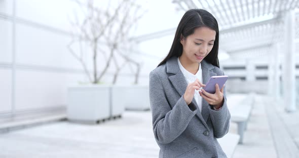 Businesswoman work on mobile phone in Hong Kong 