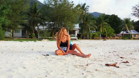 Women tan on idyllic coast beach adventure by blue sea and white sandy background of Koh Phangan nea