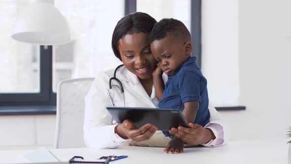 Doctor Showing Tablet Pc To Baby Patient at Clinic