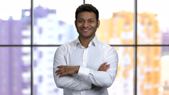 Portrait of a Young Happy Hindu Man with His Arms Crossed Shows Thumb Up