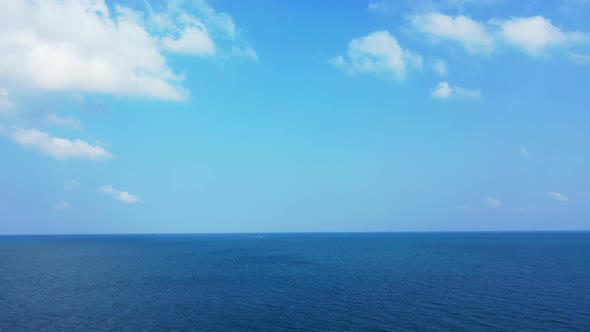 Deep ocean abstract background. Beautiful bright blue sky with fluffy white clouds above deep blue w