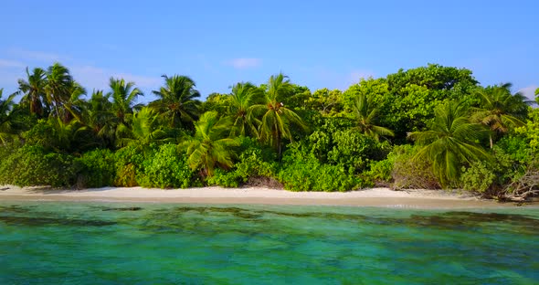 Wide aerial clean view of a paradise sunny white sand beach and blue ocean background in colorful 4K