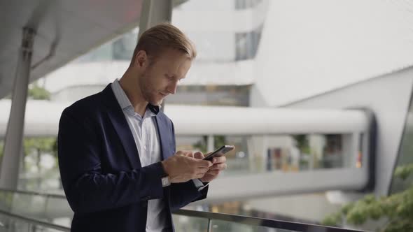 Businessman checking smartphone, Bangkok, Thailand