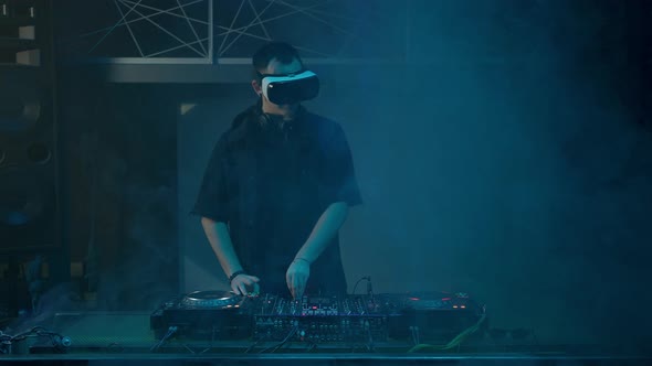DJ in VR Glasses Works at Controller and Moves to Beats