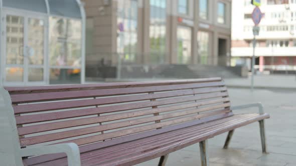 Young Man Coming, Sitting on Bench and Opening Laptop