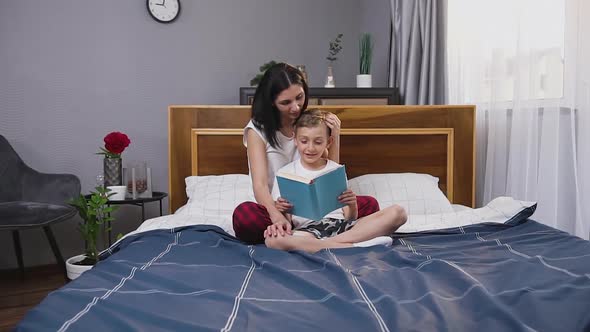  Mother and Son which Spending their Free Time with Interesting Book at Home