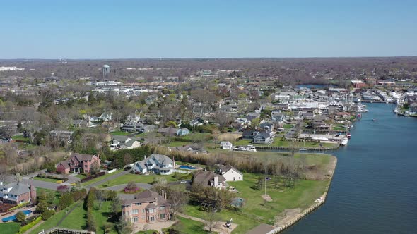 A high angle drone view over Bay Shore, NY, on a sunny day with clear skies. The camera dolly in ove