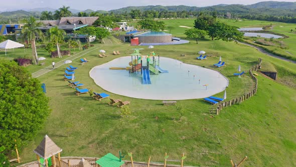 Aerial flyover playground and pool for kids at Vistas Golf Resort on Dominican Republic