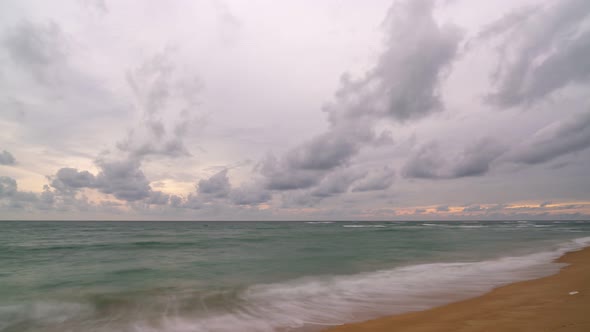 Timelapse clouds and wave crashing on beach