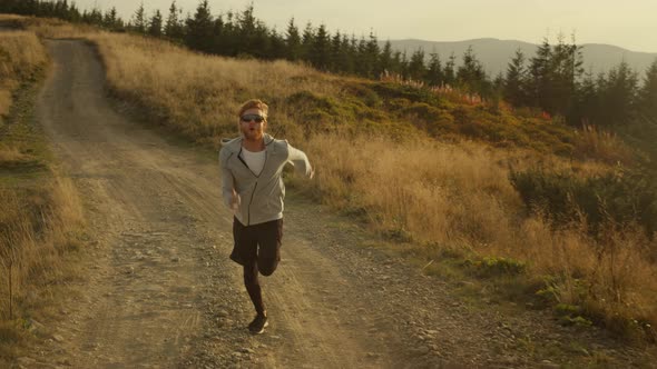 Strong Athlete Jogging on Dirty Road