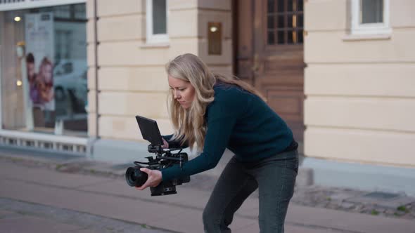 Female Film Maker Focusing Film Camera