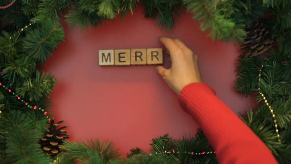 Merry Christmas Female Hand Making Phrase of Cubes