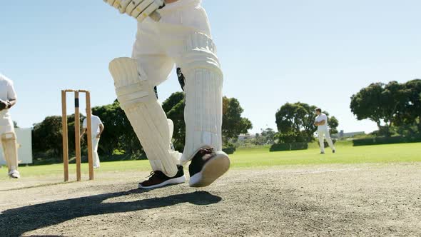 Batsman playing a defensive stroke during cricket match