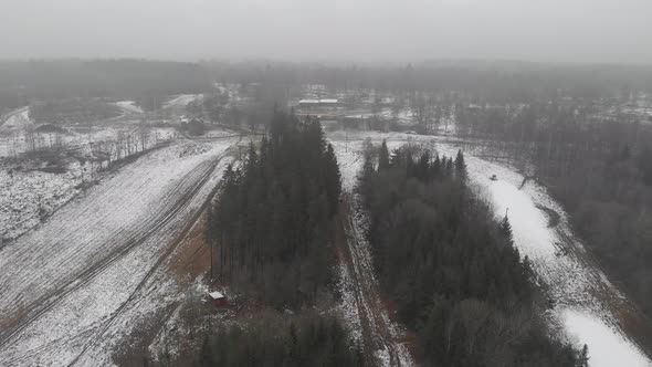 Empty Ski Resort First Snow Winter Forest Landscape Pull Back Aerial