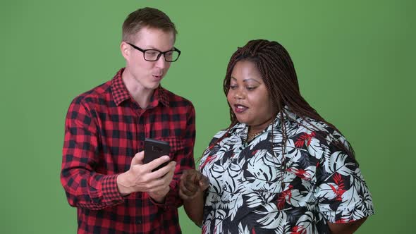 Overweight African Woman and Young Scandinavian Man Together Against Green Background