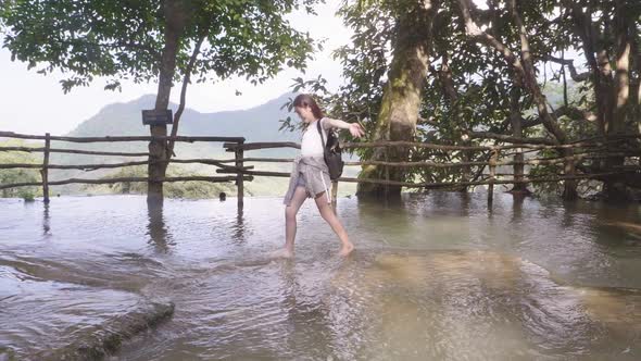 Tourist Woman Walking In The River