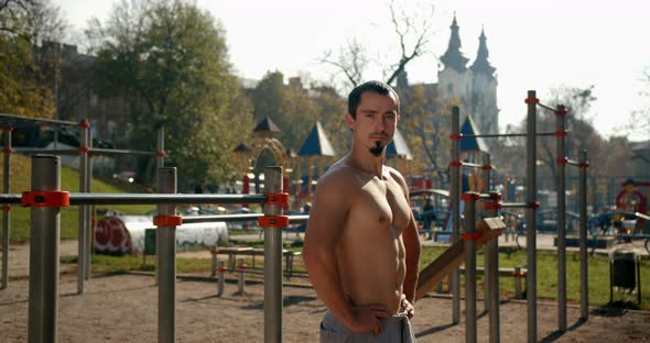 A Man Is Standing on the Sport Area After Training in Sunny Weather 