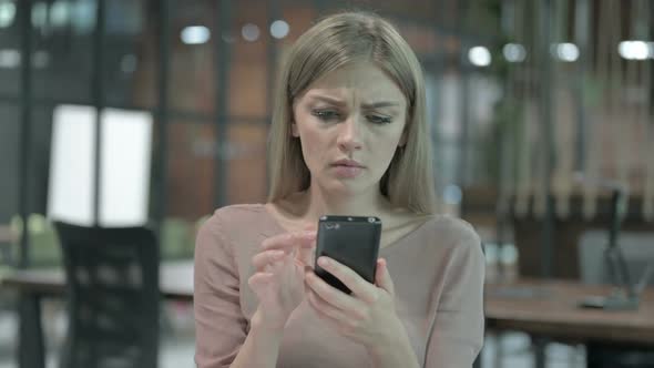 Portrait Shoot of Young Woman Getting Upset on Smartphone