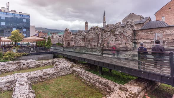 Historical Taslihan ruins timelapse with the old watch tower and minaret of Gazi Husrev mosque