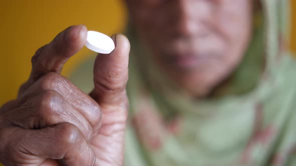 Senior Women Holding a Medical Pills