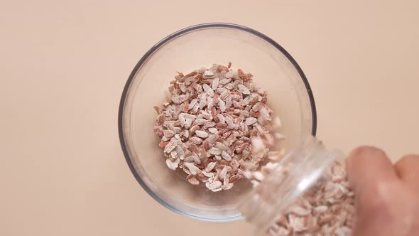 Red Flattened Rice in a Bowl on Color Background