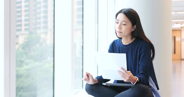 Woman reading on paper note in university campus