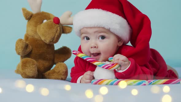 Portrait of Adorable Infant Baby Girl Wearing Santa Hat. Christmas Celebration Concept.