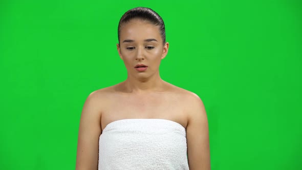 Shocked Woman with Goggled Eyes Staring at the Camera on Green Screen at Studio