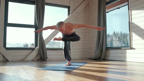 Athletic and Handsome Mature Man Practicing Yoga Asana