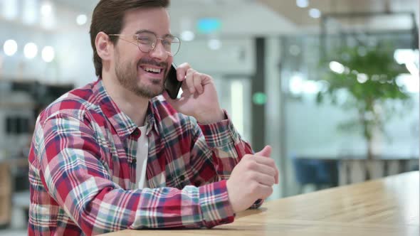 Friendly Male Designer Talking on Smartphone