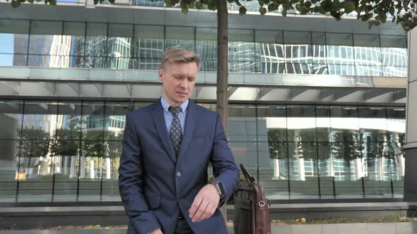 Businessman Leaving for Meeting After Watching Time