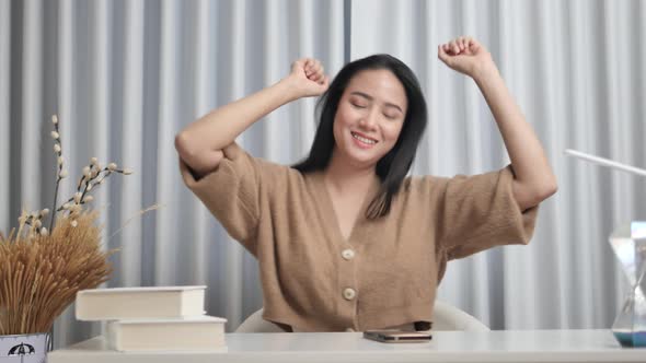 Cute teenage girl listening to music on mobile phone and dancing happily.