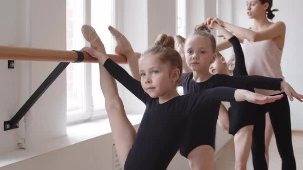 Ballet Coach Teaching Four Little Girls