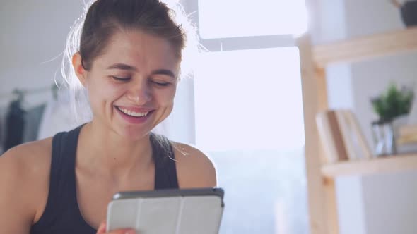 Smiling Caucasian Female Using Tablet in Slowmotion