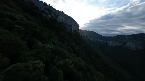 Drone Shot with the Rays of the Sun Disappearing Behind the Mountain