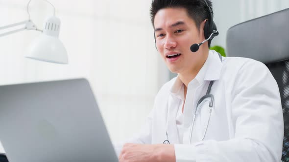 Asian male medical doctor talking virtual online with patient at home.