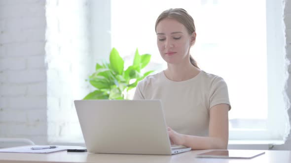 Busy Woman Typing on Laptop in Office