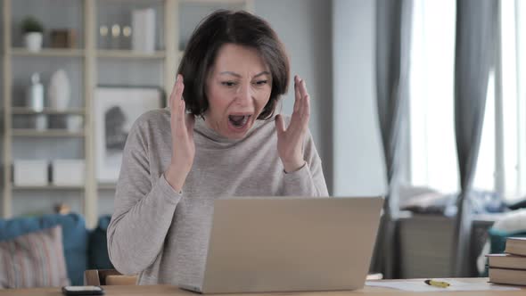 Shocked, Stunned Old Senior Woman Wondering and Working on Laptop