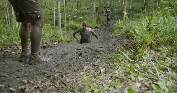 people running a mud race high speed and slow motion