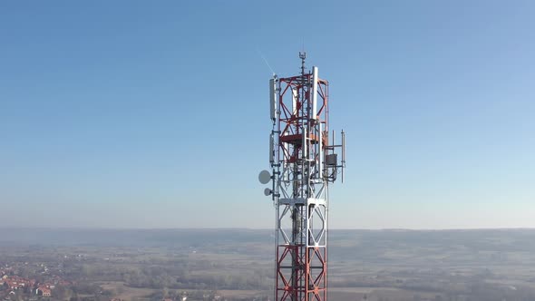 Red and white metal of telecommunication antenna tower 4K drone video