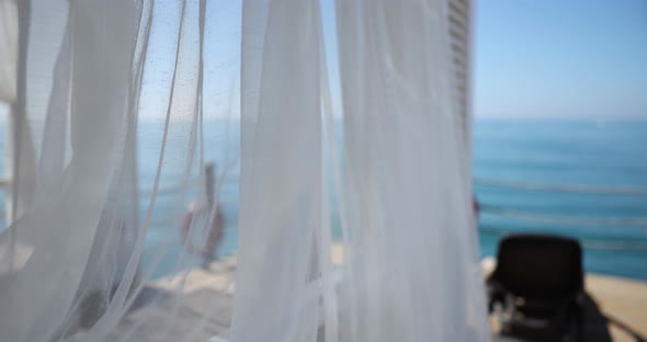 White Curtain Revealing Peaceful Tropical Beach and Sea