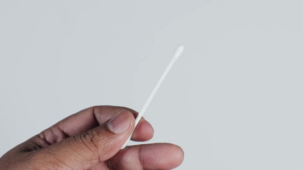 Hand Holding A Single Cotton Swab