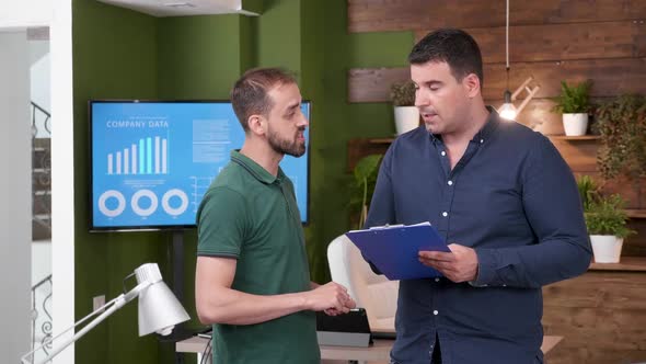 Two Male Colleagues Having a Talk in the Office