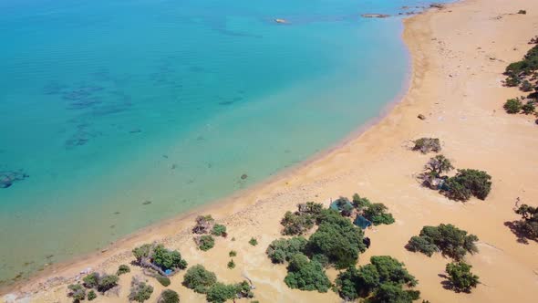 Orange sand dunes and savin trees. Beach of Agios Ioanis. Gavdos Island. Greece